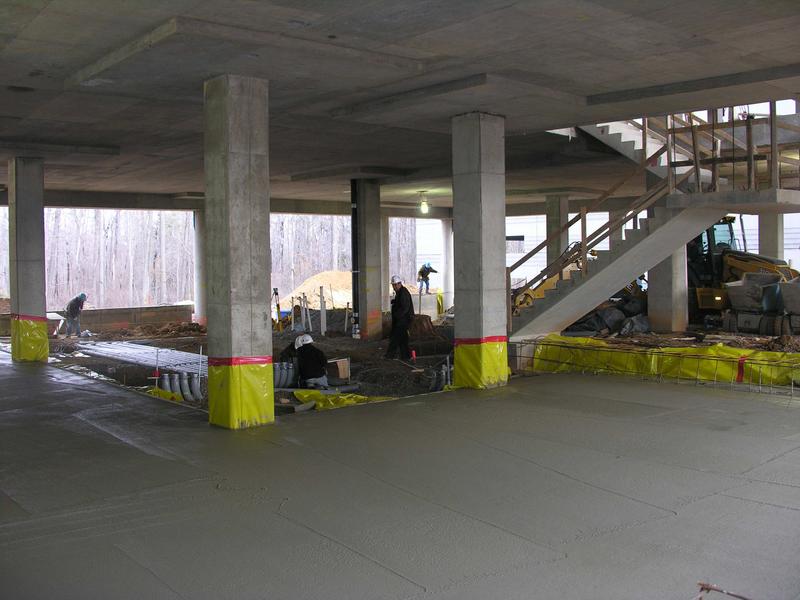 Laying the remaining area of the first floor in the deli area; note the pipes being laid out prior to the pouring of the concrete