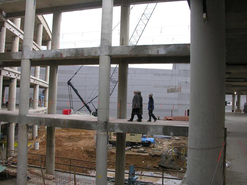 Connecting walkways between south and north wings. In the background a crane is lifting an exterior wall panel into place.