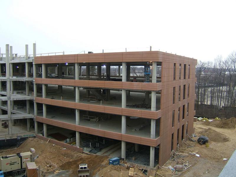 North wing of building with much of the concrete facade in place. Note welder on fourth floor putting in clips to hold windows.