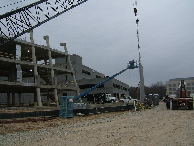 Another view of auditorium wall construction. Parking garage is in background. UMD building is in background to right.