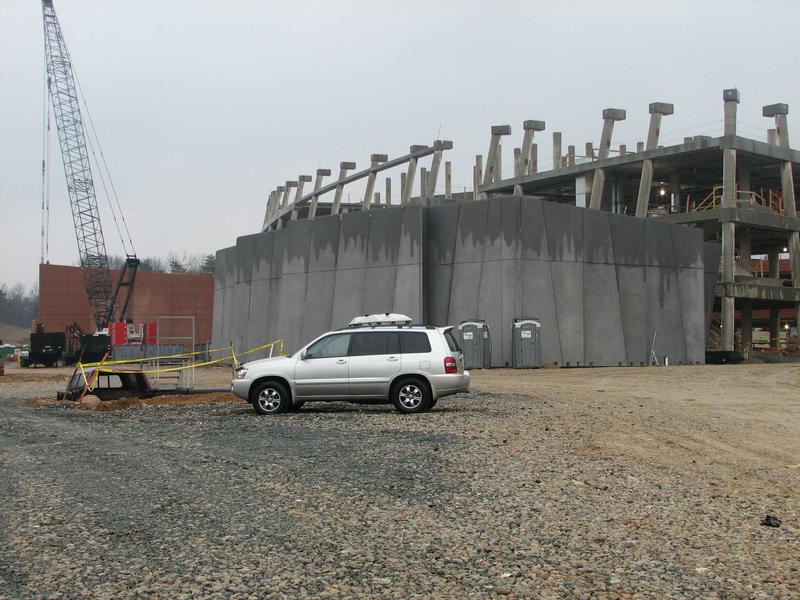 Front side of NCWCP showing auditorium walls in foreground and red concrete facing on two story data center wing