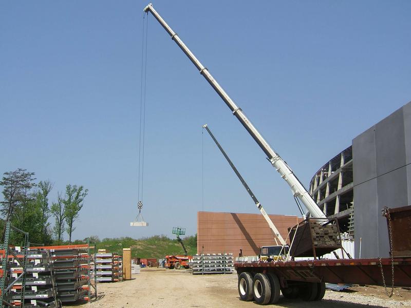 Construction materials being delivered to the roof by large crane