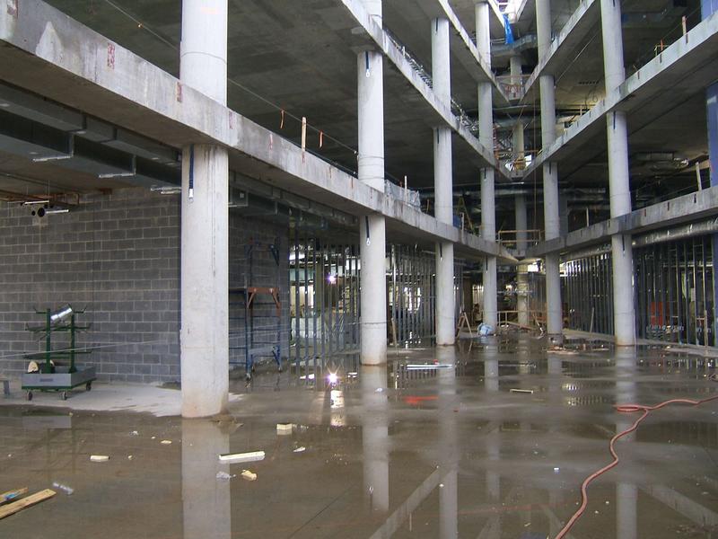 View from atrium towards front entrance area showing studding on both sides.