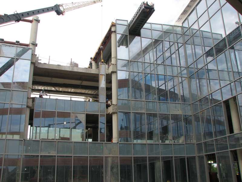 Window glass being installed on the north side of the south wing.  Picture was taken from the courtyard outside the location of the deli. 