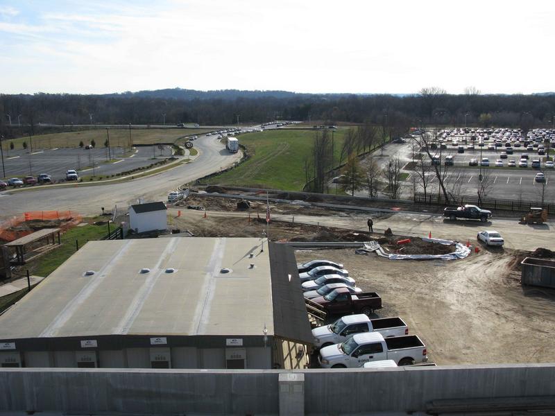 Entrance road from parking garage. Center right shows construction of curbing for a small parking lot next to the garage.