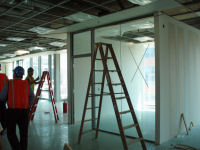 Sheetrock and glass walls are being installed in some offices and conference rooms.