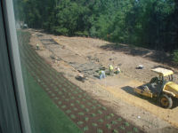 Workers prepare the rear "PEPCO" access road for paving.