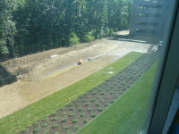 A northward view from the 2nd floor EMC area, where watering of the landscaping along the PEPCO road is helping establish the recently laid sod. 
