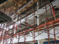 Looking upward along south side of atrium; scaffolding supports platform for ceiling installation