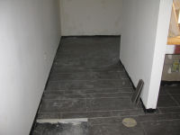 Tile floor in fitness room bathroom