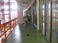 Laying carper tiles along the hallway in front of the conference rooms on the second floor