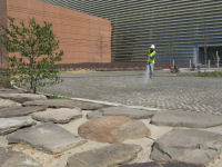 Putting the finishing touches on the cobblestone entrance drive.